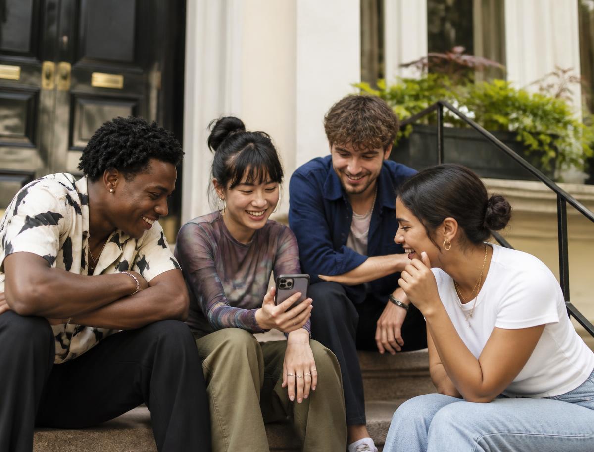 A group of friends checking their circle progress together on a phone